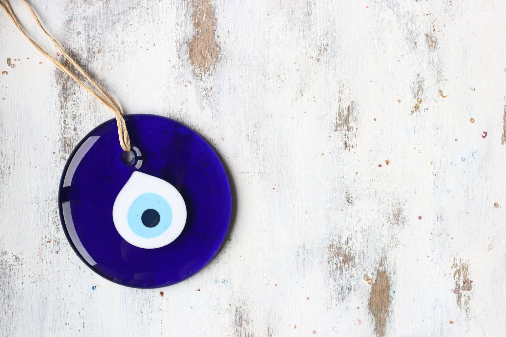 Evil eye bead, Turkish nazar bead on a white wooden background