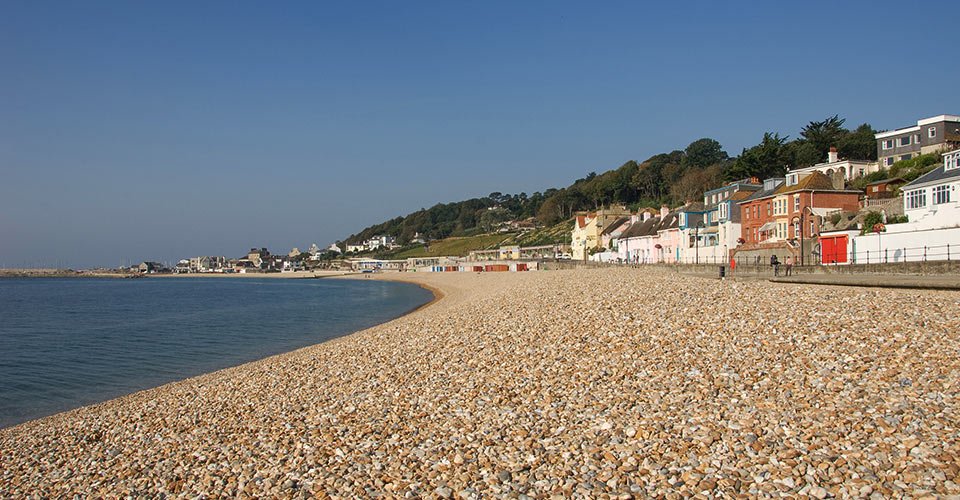 Cobb Gate Beach & seafront in early morning sunlight, Lyme Regis