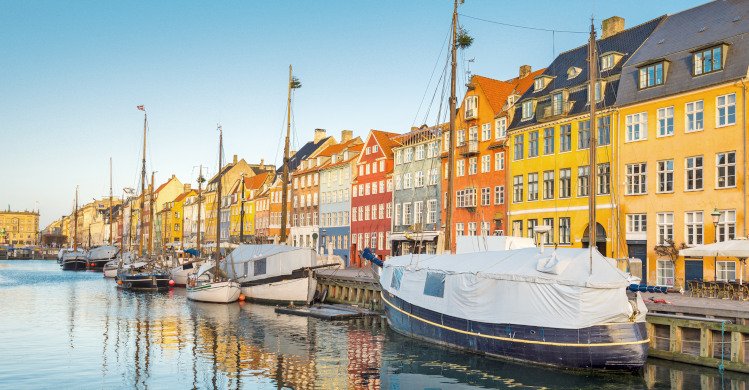 Wide angle view of the colourful buildings along Nyhavn in Copenhagen, Denmark, Europe.