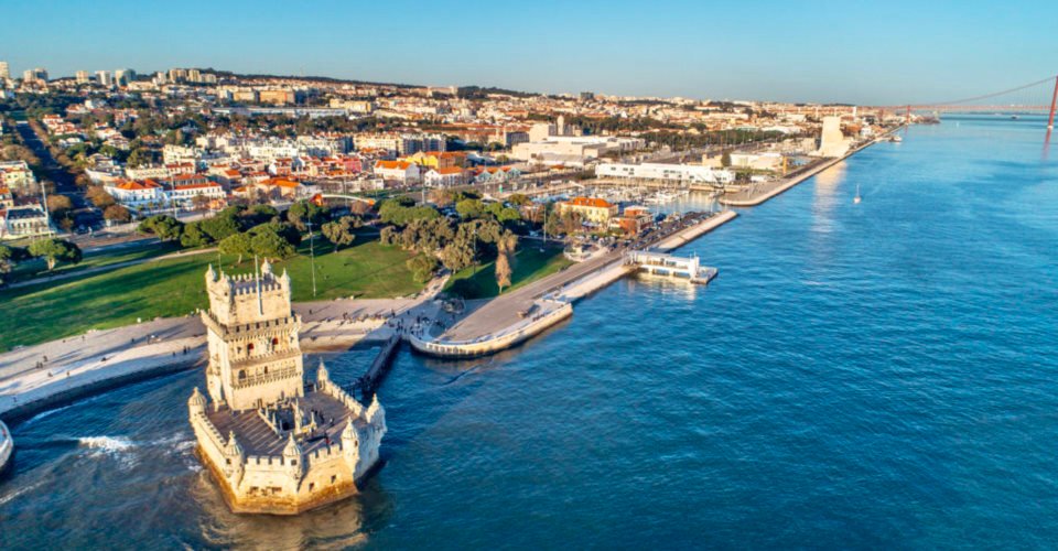 Aerial panorama of Belem Tower and Belem district at sunset.Tower of St Vincent on the bank of the Tagus River with discovery monument and 25 April bridge.Lisbon,Portugal.Amazing destinations