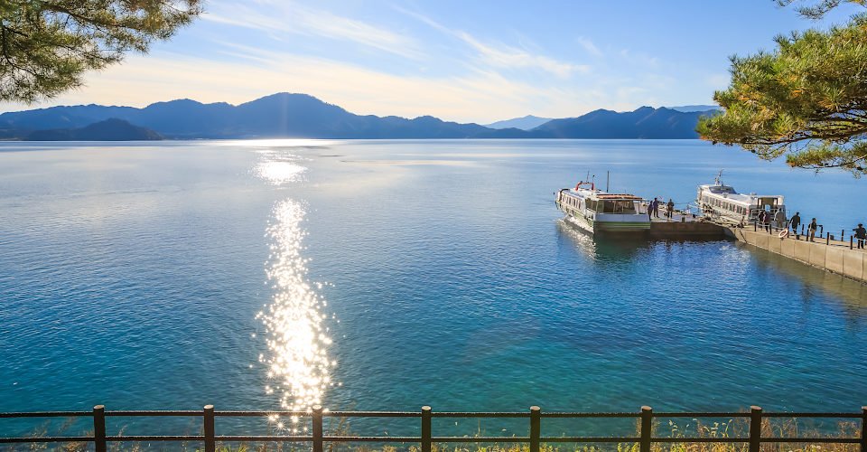 Passenger ships with sparkling sunshine in Lake Tazawa - Senboku, Akita, Japan; Shutterstock ID 378875515; purchase_order: BB23-28333 at; job: ; client: AIDA Cruises; other: 