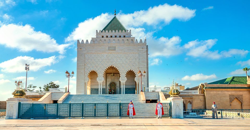 RABAT, MOROCCO - JULY 05, 2018:  Mausoleum with guards at tomb of King Mohammed V in courtyard of incomplete Mosque. North Africa
 