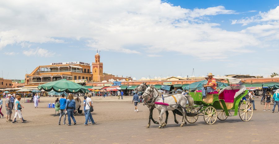MARRAKESH, MOROCCO, APRIL 3, 2015: Jemaa el-Fnaa square -  Horse drawn carriage waits for tourists 