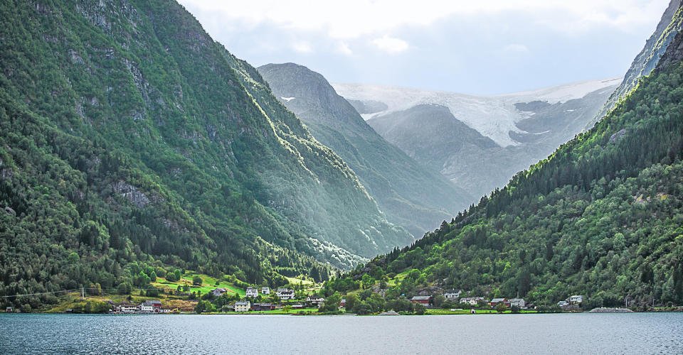Folgefonna Glacier as seen from the road to Odda.  Folgefonna is a collective term for three plateau glaciers in the Hardanger region of Hordaland county, Norway. They are located on the Folgefonna peninsula in the municipalities of Odda, Jondal, Kvinnherad, and Etne.