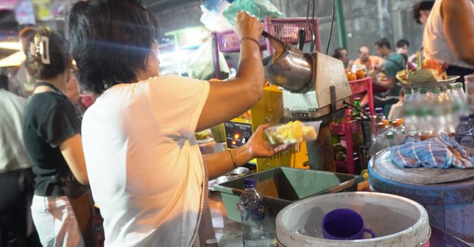TOUR OPERATOR GATEWAY - Vendor Preparing Freshly Squeezed Juice at a Night Market Food Stall