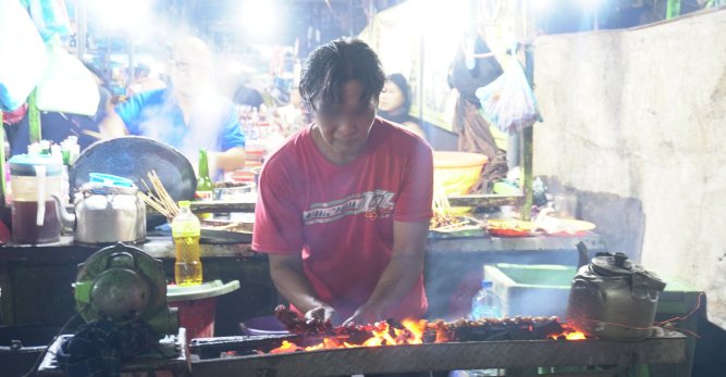 TOUR OPERATOR GATEWAY - Street Vendor Busy Preparing Satay Skewers for Eager Customers