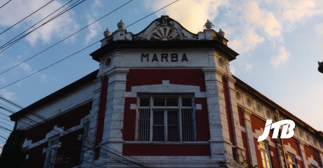 TOUR OPERATOR GATEWAY - A stunning view of the Marba Building in Semarang with its striking facade against the evening sky.