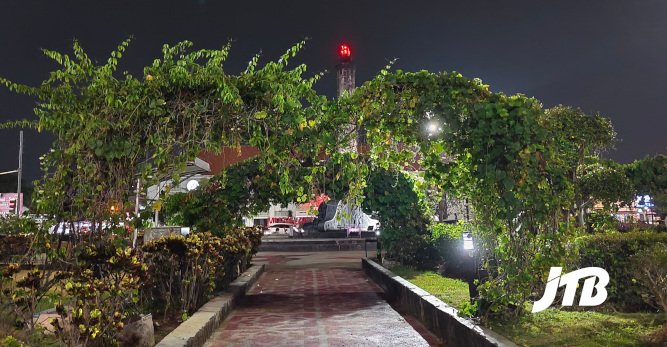 TOUR OPERATOR GATEWAY - A charming walkway surrounded by greenery glows under the evening lights