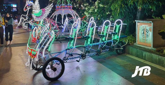 TOUR OPERATOR GATEWAY - A colorful illuminated carriage decorates the vibrant night scene