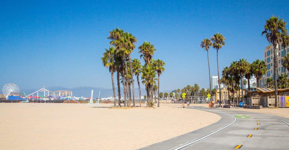 Beautiful morning sunrise lights at the Venice beach in Los Angeles. Bicycle lane by the beach.