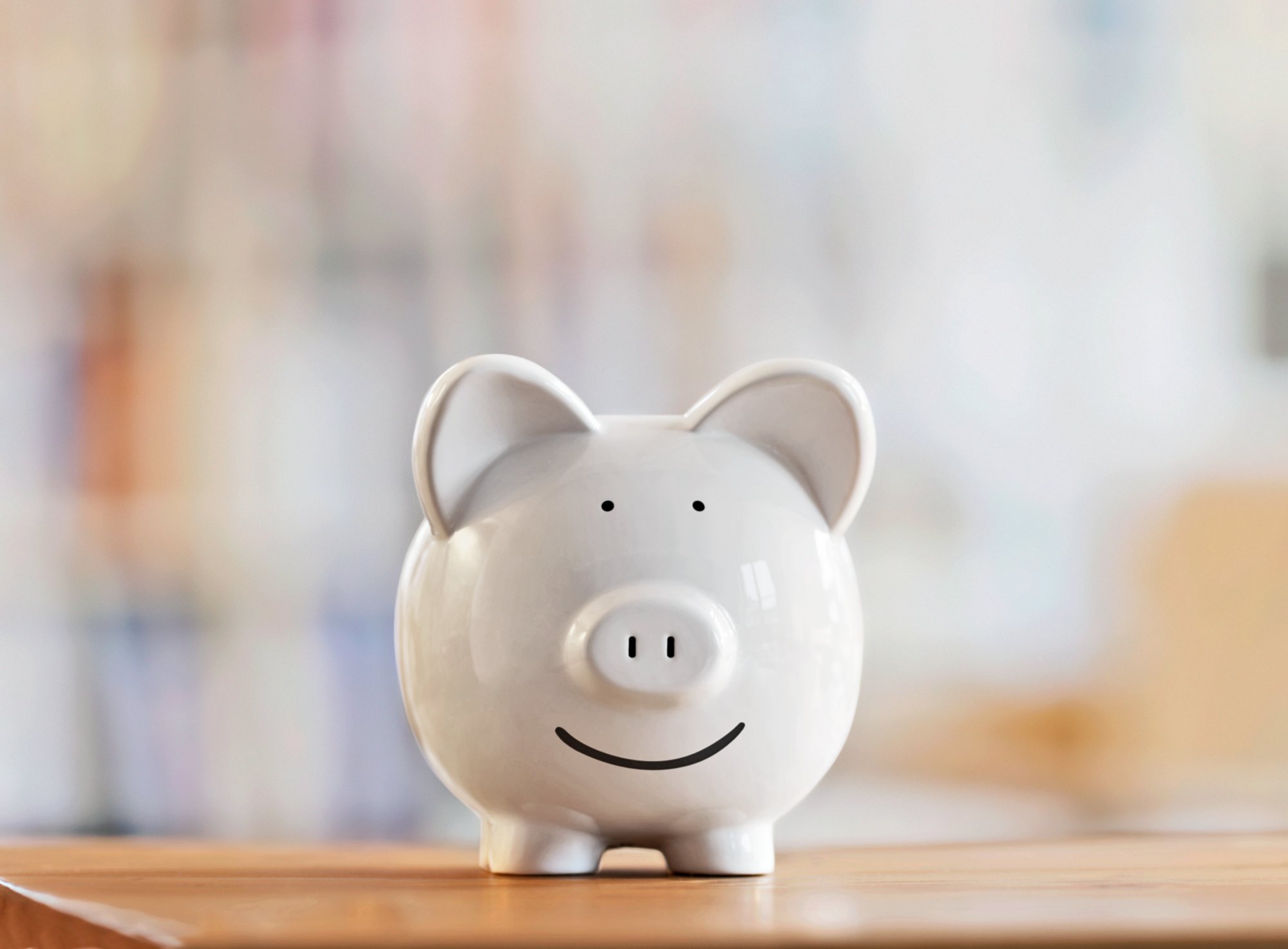 Smiling piggy bank on wooden table