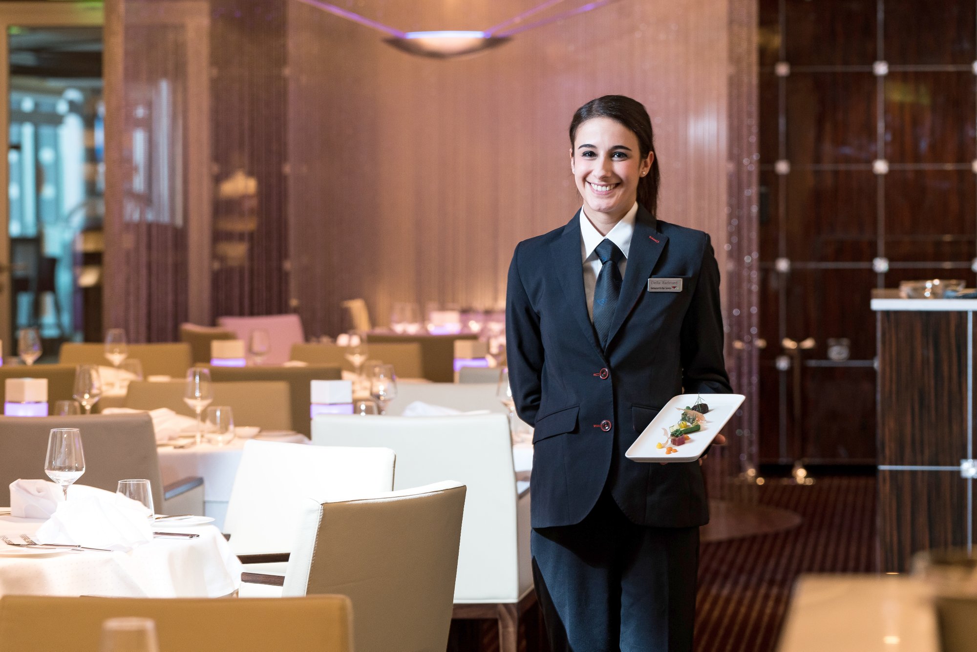 AIDA restaurant manager smiles into the camera