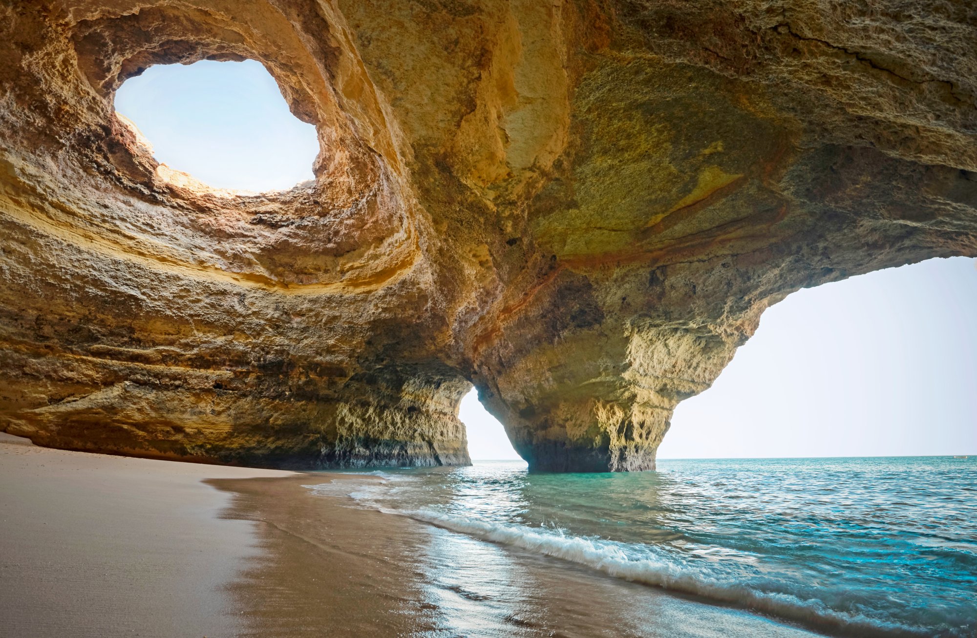 Portugal, beach of Benagil, cave, woman sitting at seafront