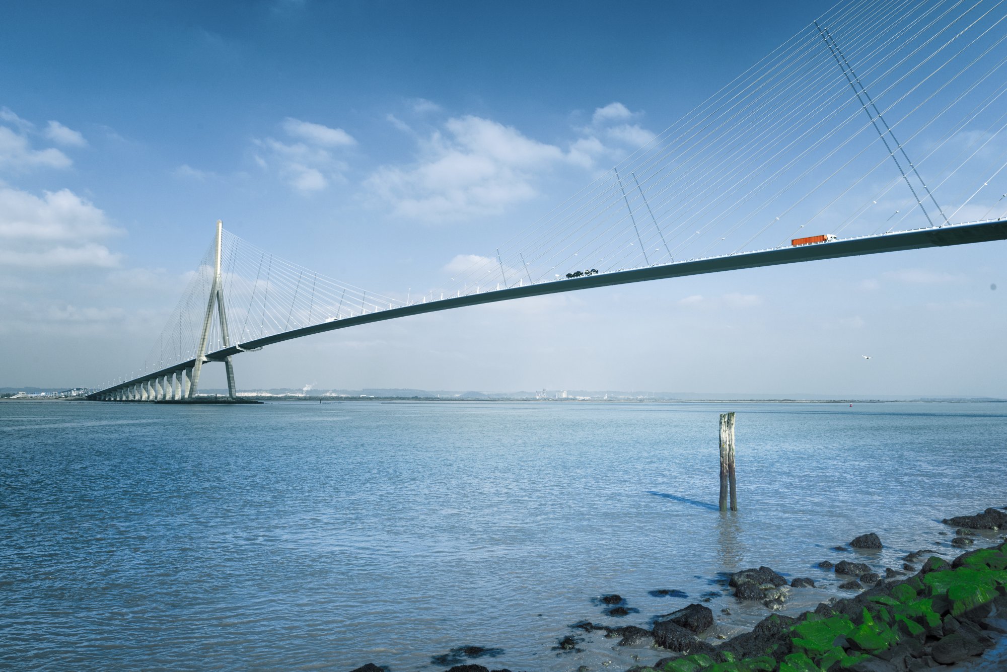 pillar of the bridge "Pont de Normandie" reflected in the Seine river at Le Havre, France