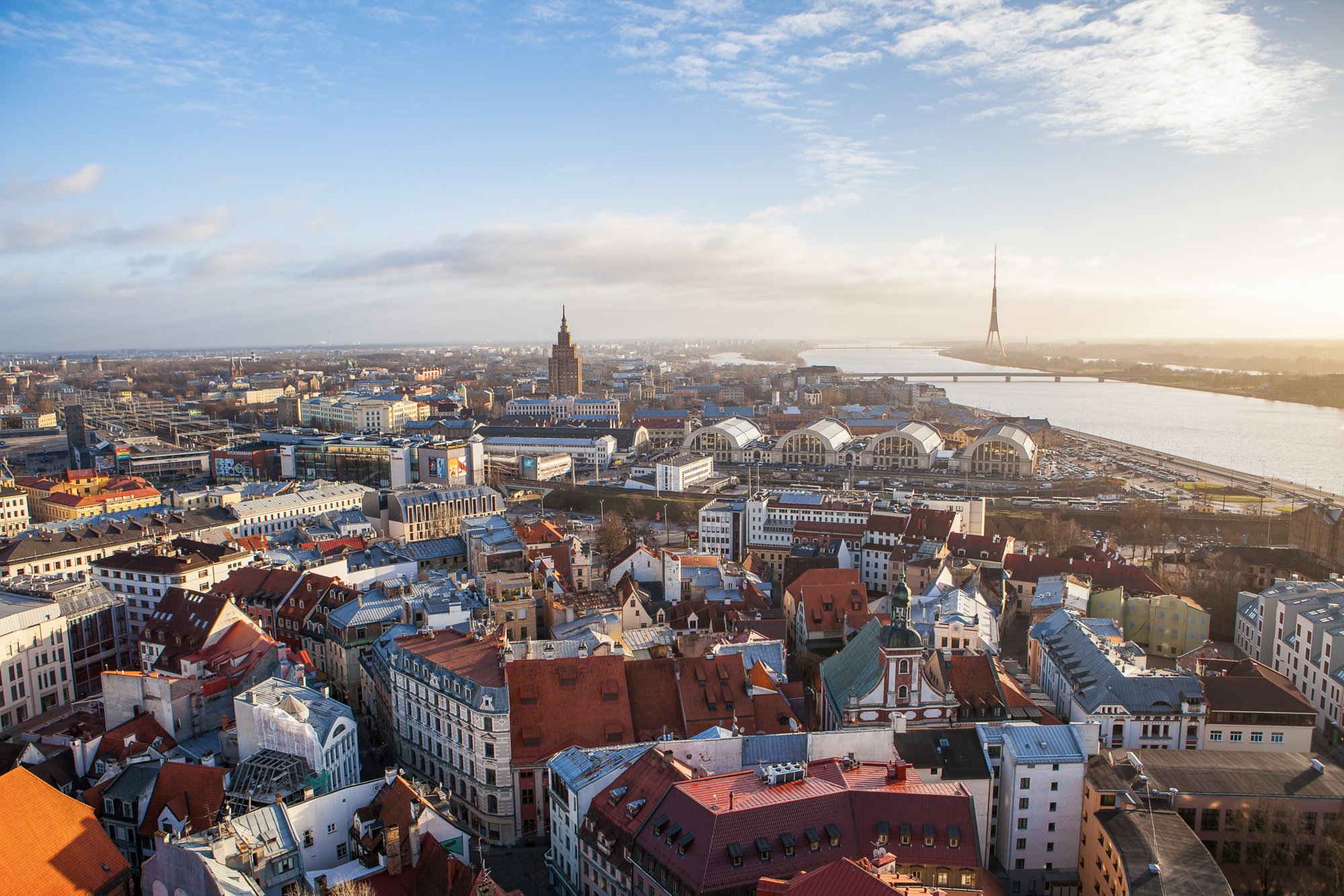 RIGA, LATVIA - 25 DEC 2016. View of old town, Daugava River and Riga TV and radio tower - Latvia. Sunny summer day, backlight