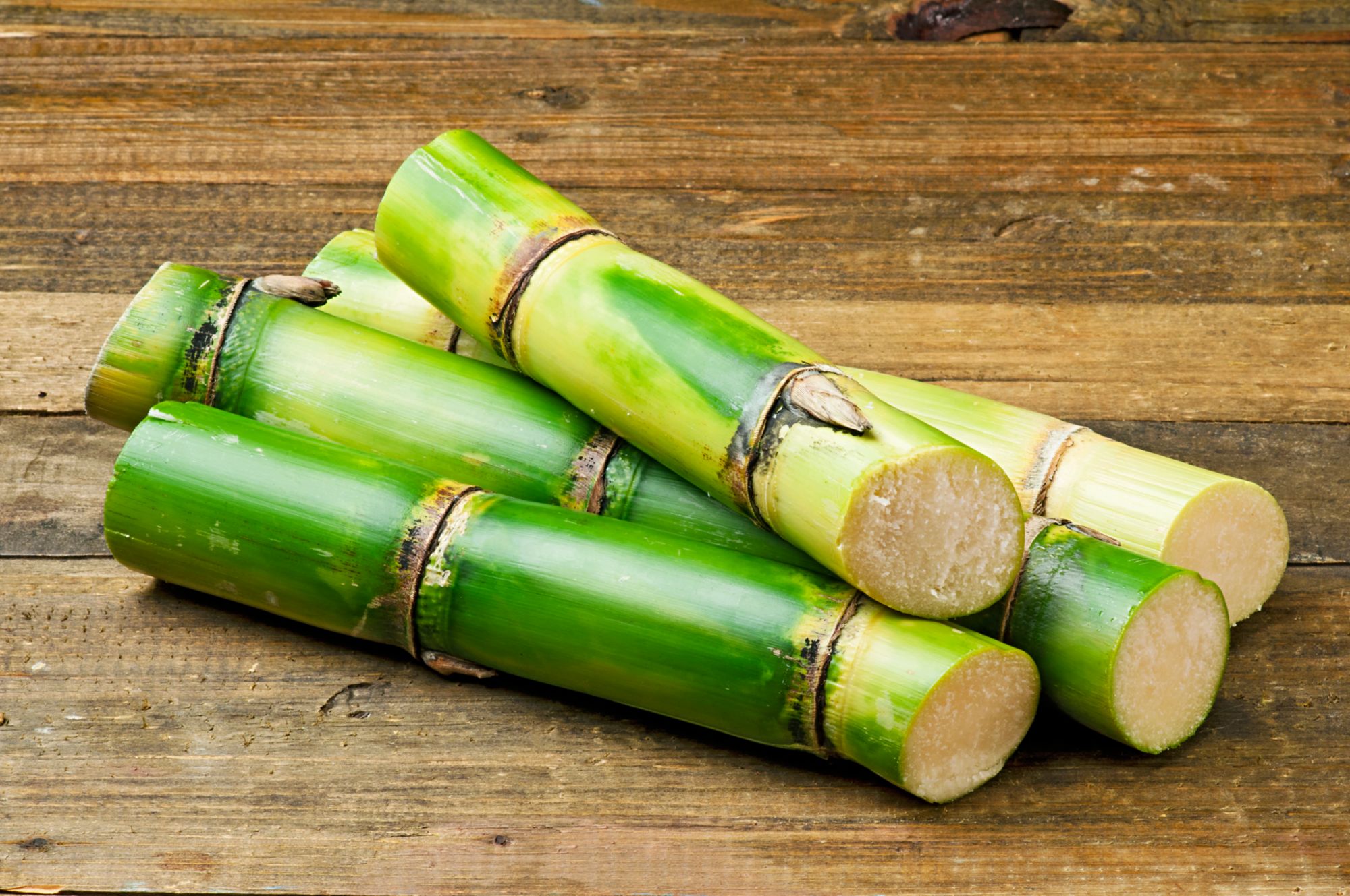Sugar Cane on Wood Background.