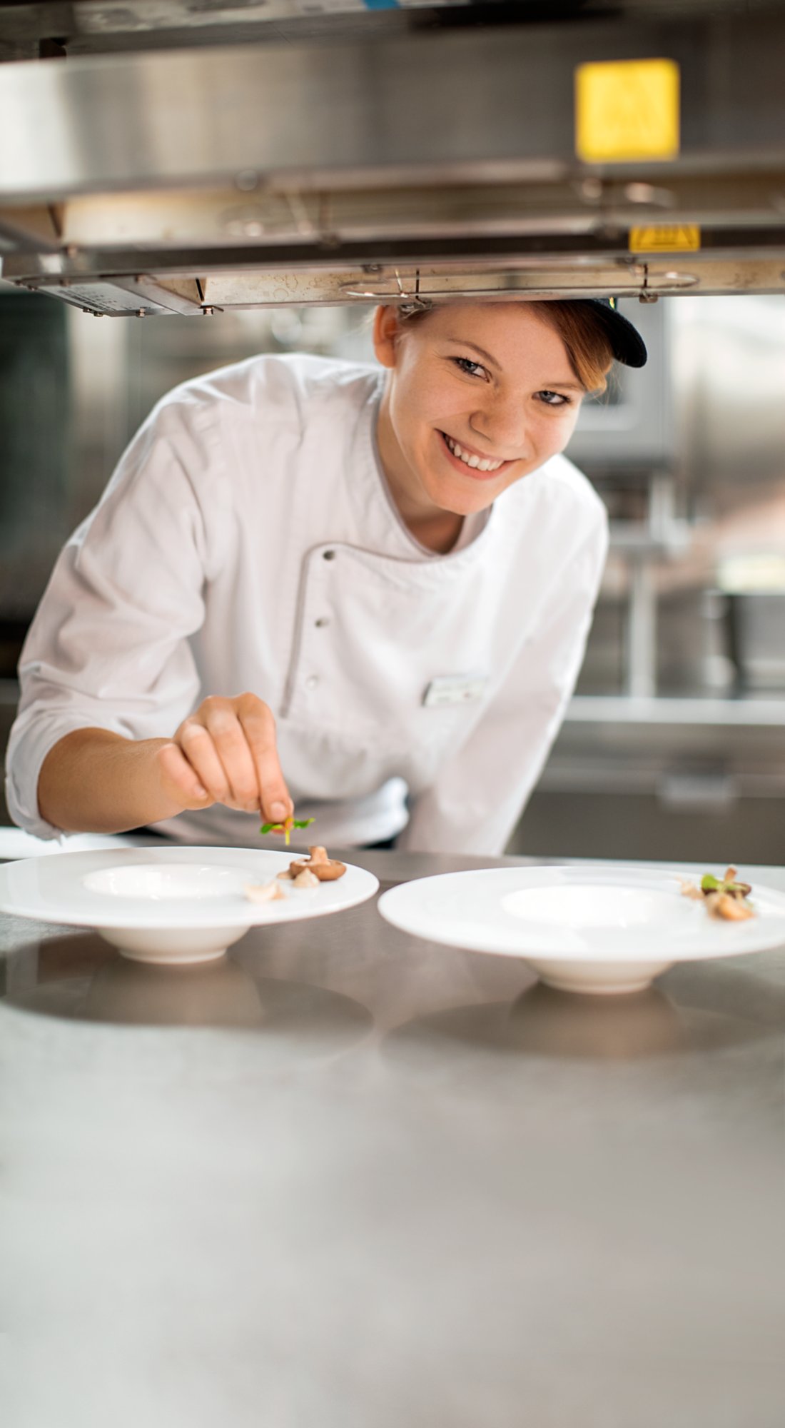 Cook in the AIDA galley prepares plates