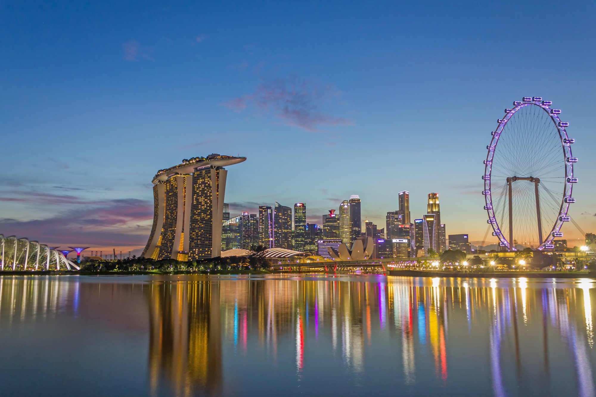 SINGAPORE - JAN 7, 2017 : Urban Skyline and View of Skyscrapers at Sunset time in Singapore, Dusk Landscape Waterfront, Reflction Technique