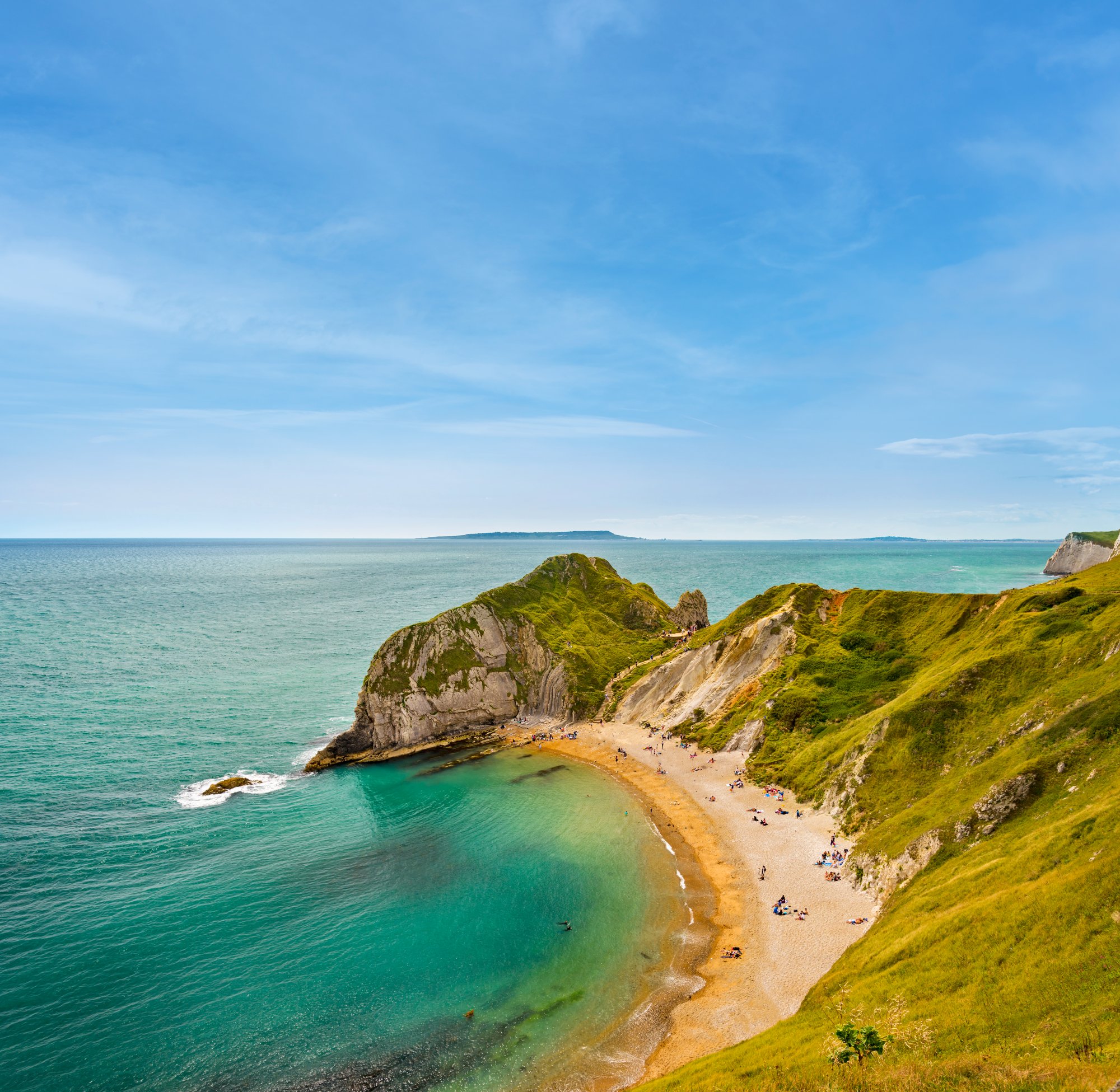 Holiday-makers bask on the world famous beaches around Durdle Door and  St Oswald's Bay