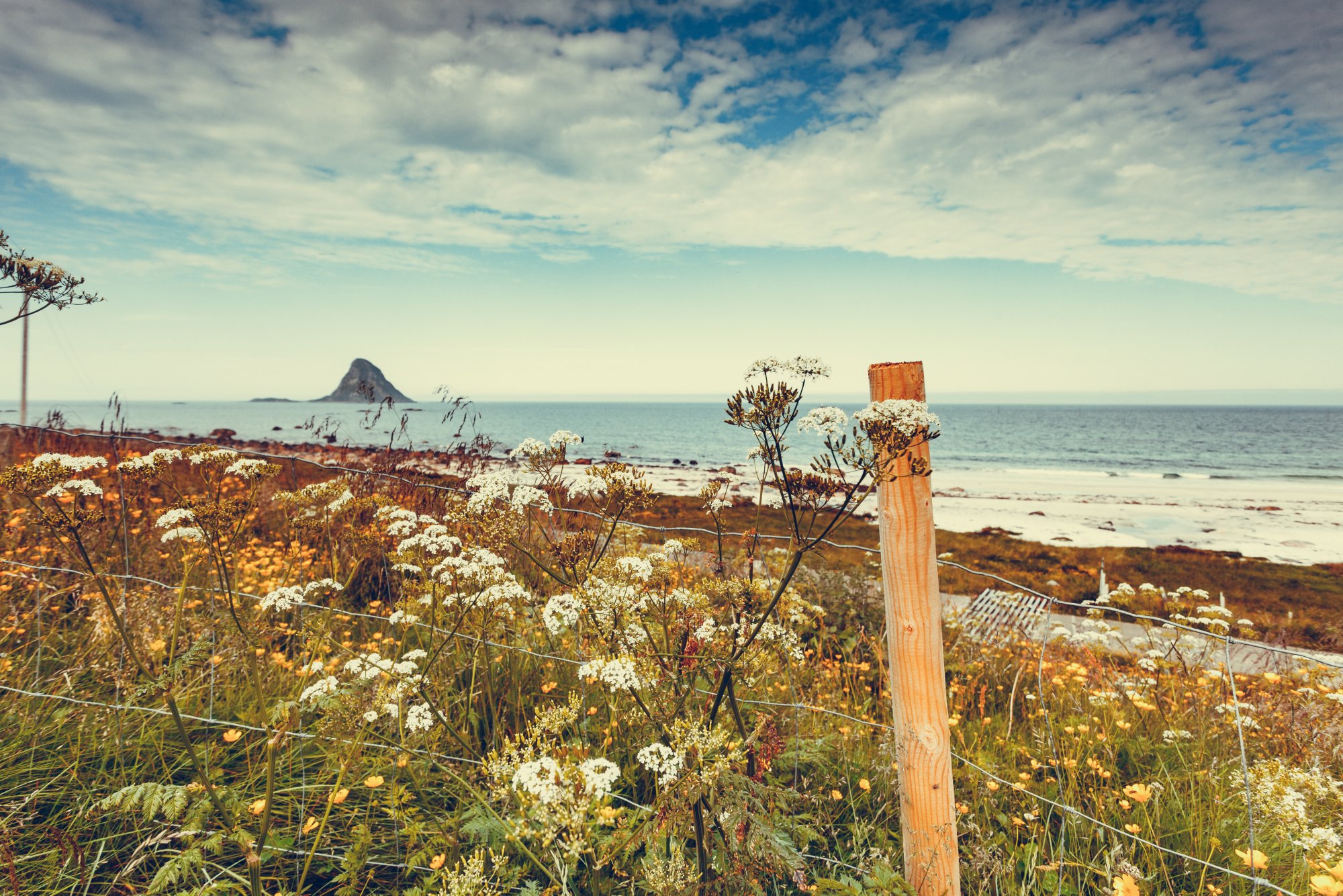 Seascape, sea coast with sandy beach and island Bleiksoya in the distance, resort Bleik Andoya Norway. Vesteralen archipelago.