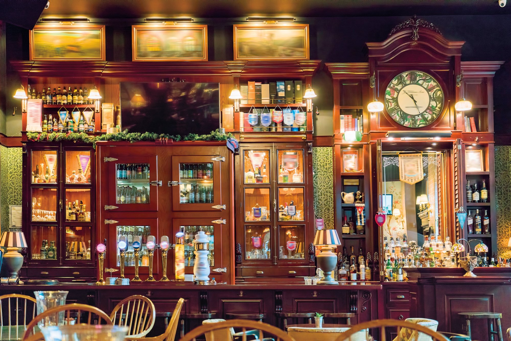 Draught beer taps in a traditional pub. Variety of alcohol drinks.