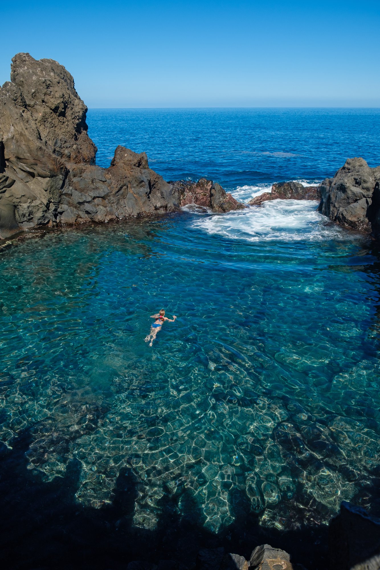 young woman swimming in natural ocean swimming pool on Tenerife island. outdoor shot in Spain. copy space.