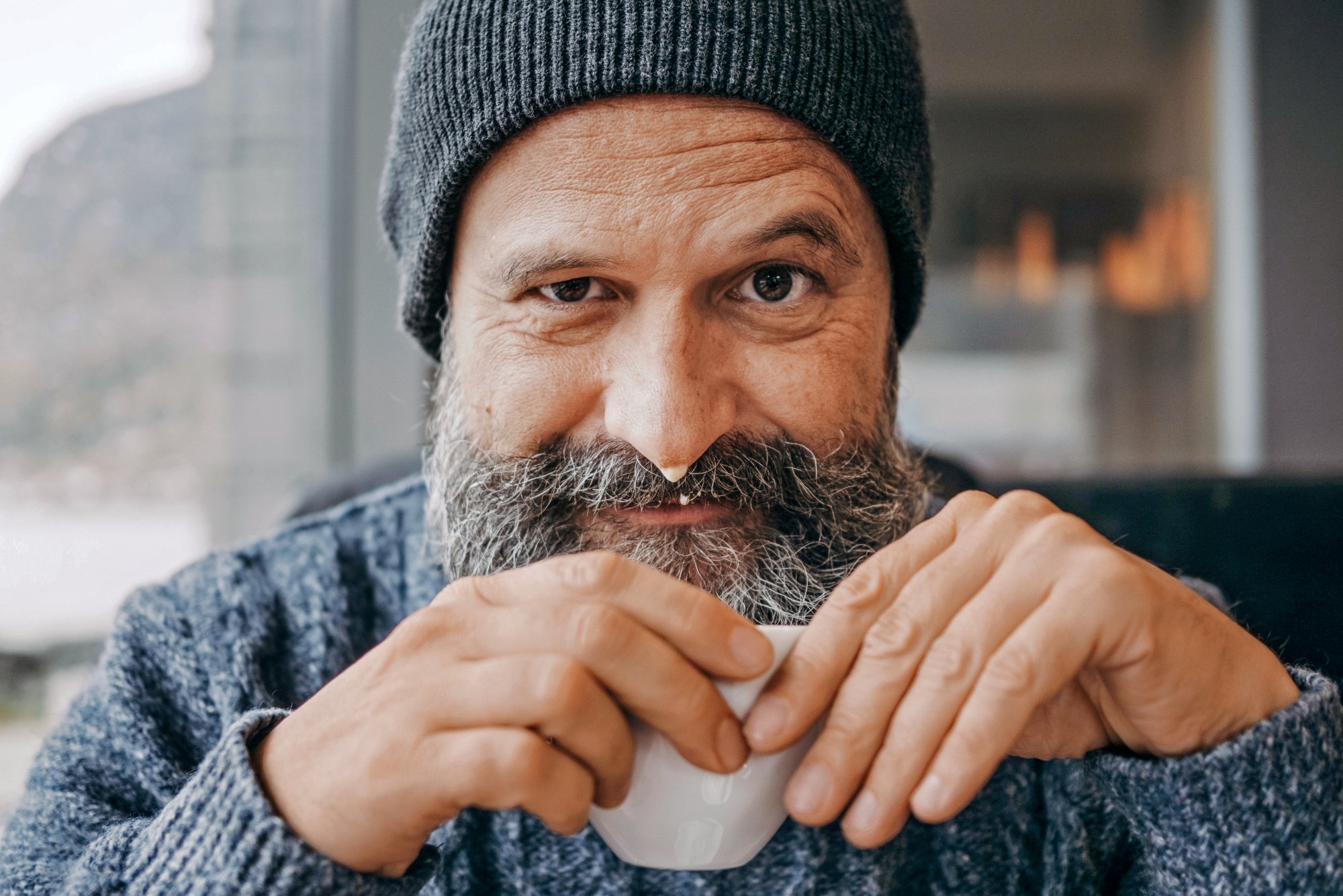 Norway, october 2018, bearded man drinking coffee and laughing