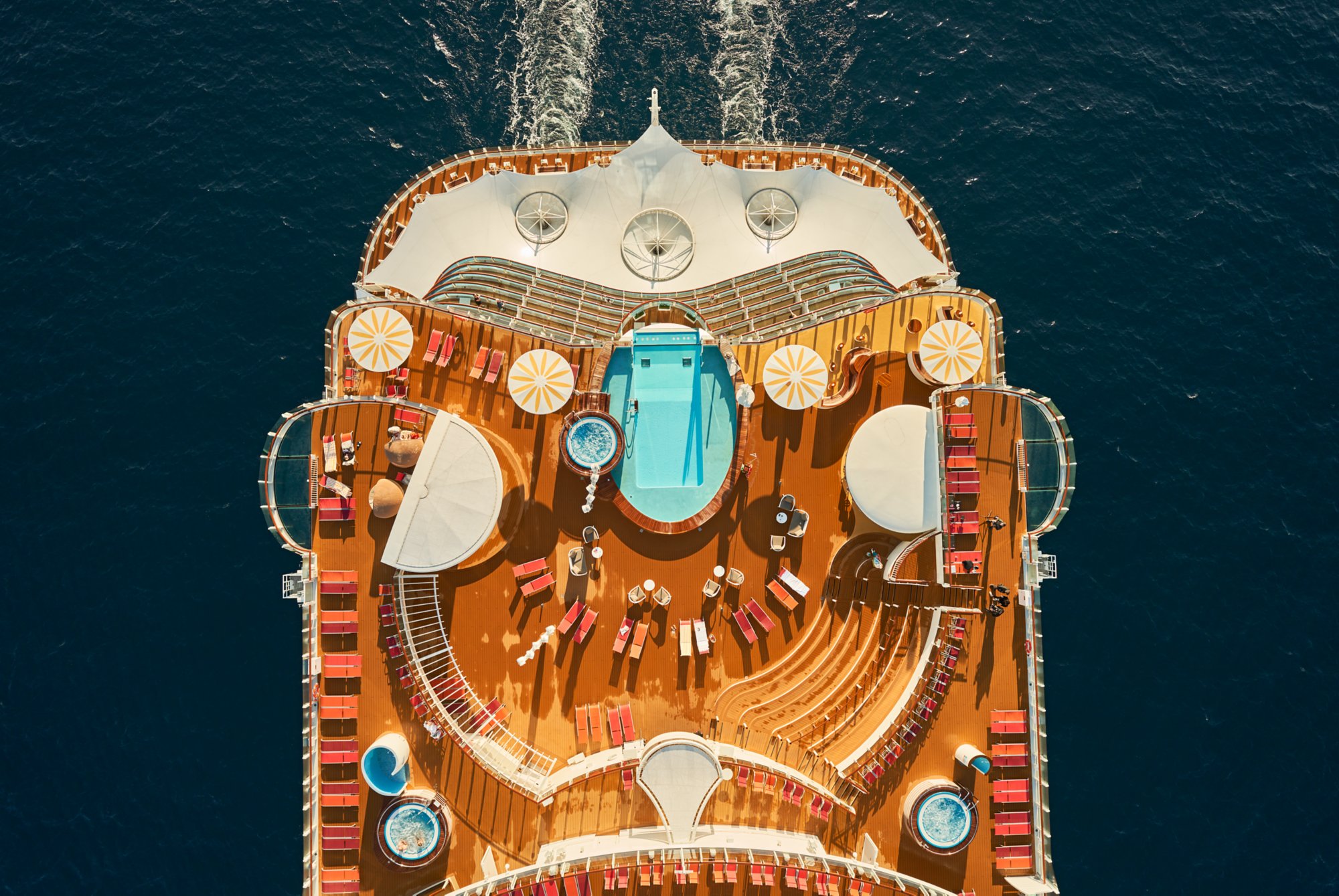 Heck der AIDAcosma aus Vogelperspektive mit Pool und Liegestühlen