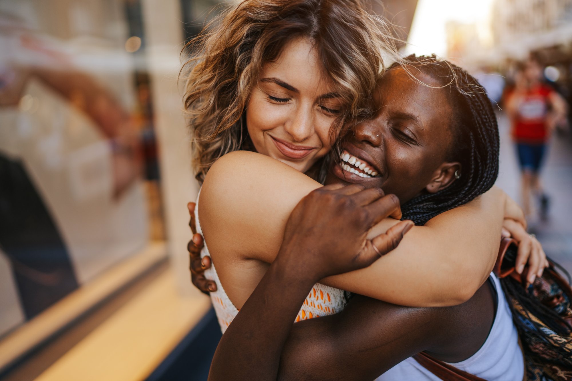 Happy young multi ethnic lesbian couple spending day together in the city