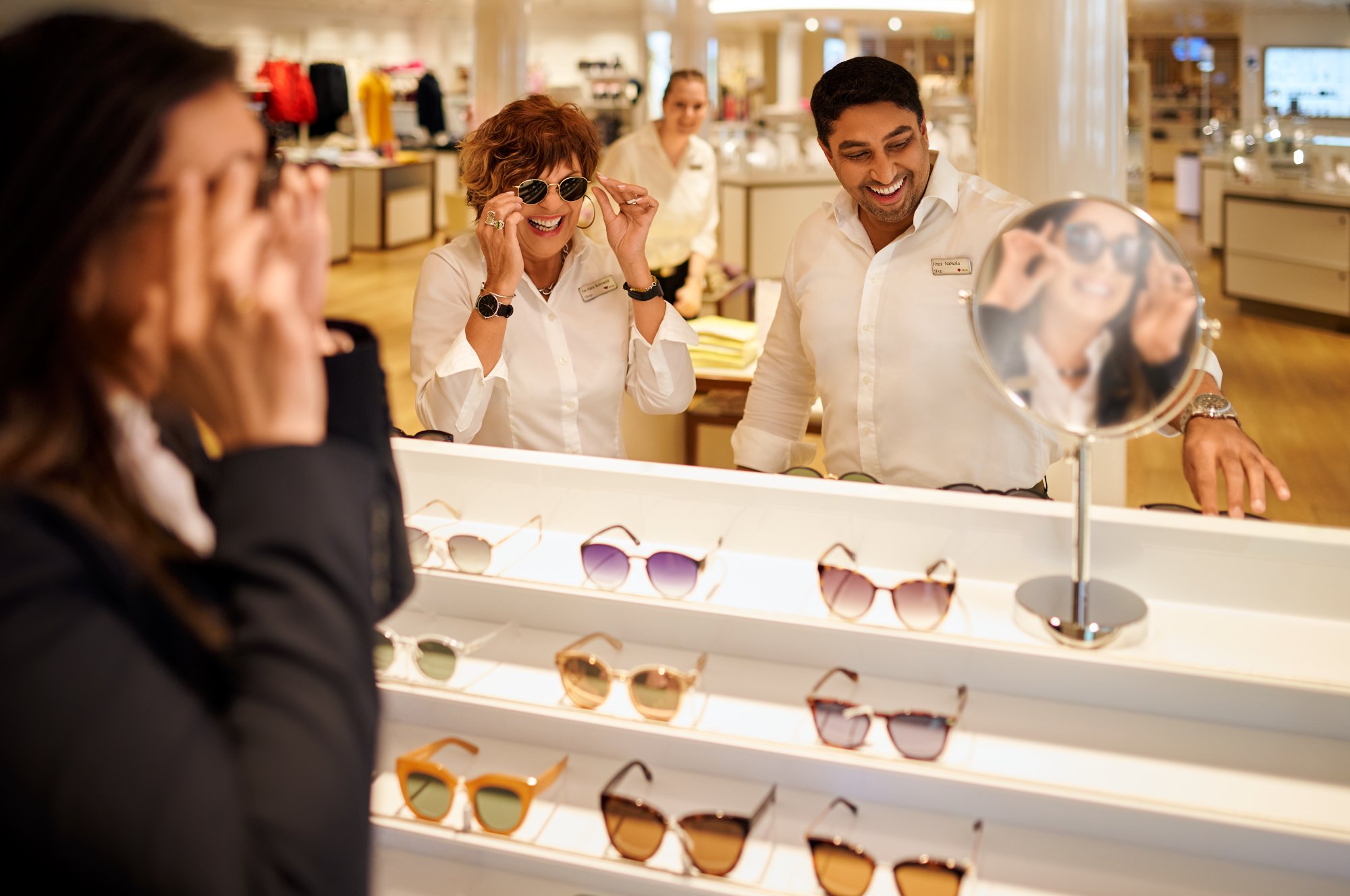 AIDA employee tries on sunglasses in the shop on board 