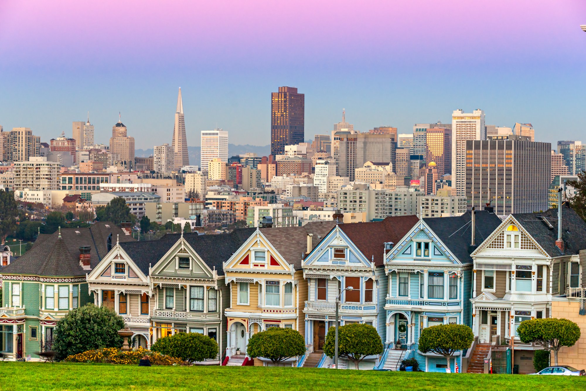 The Painted Ladies of San Francisco, California sit glowing amid the backdrop of a sunset and skyscrapers.; Shutterstock ID 170664329; purchase_order: BB24-28813mk; job: ; client: AIDA Cruises; other: 