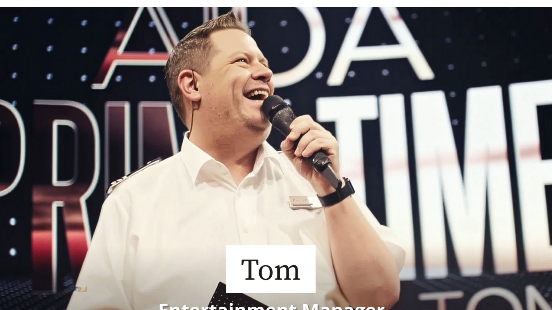 Tom Ahrendt holds a microphone in his hand