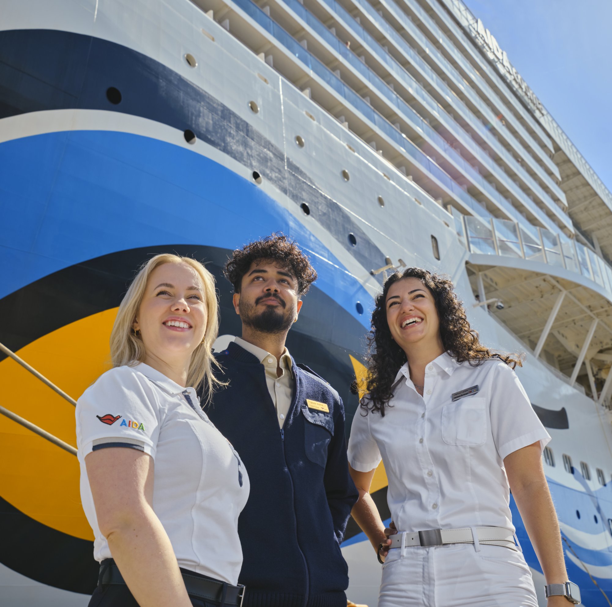 AIDA crew members in front of AIDA ship