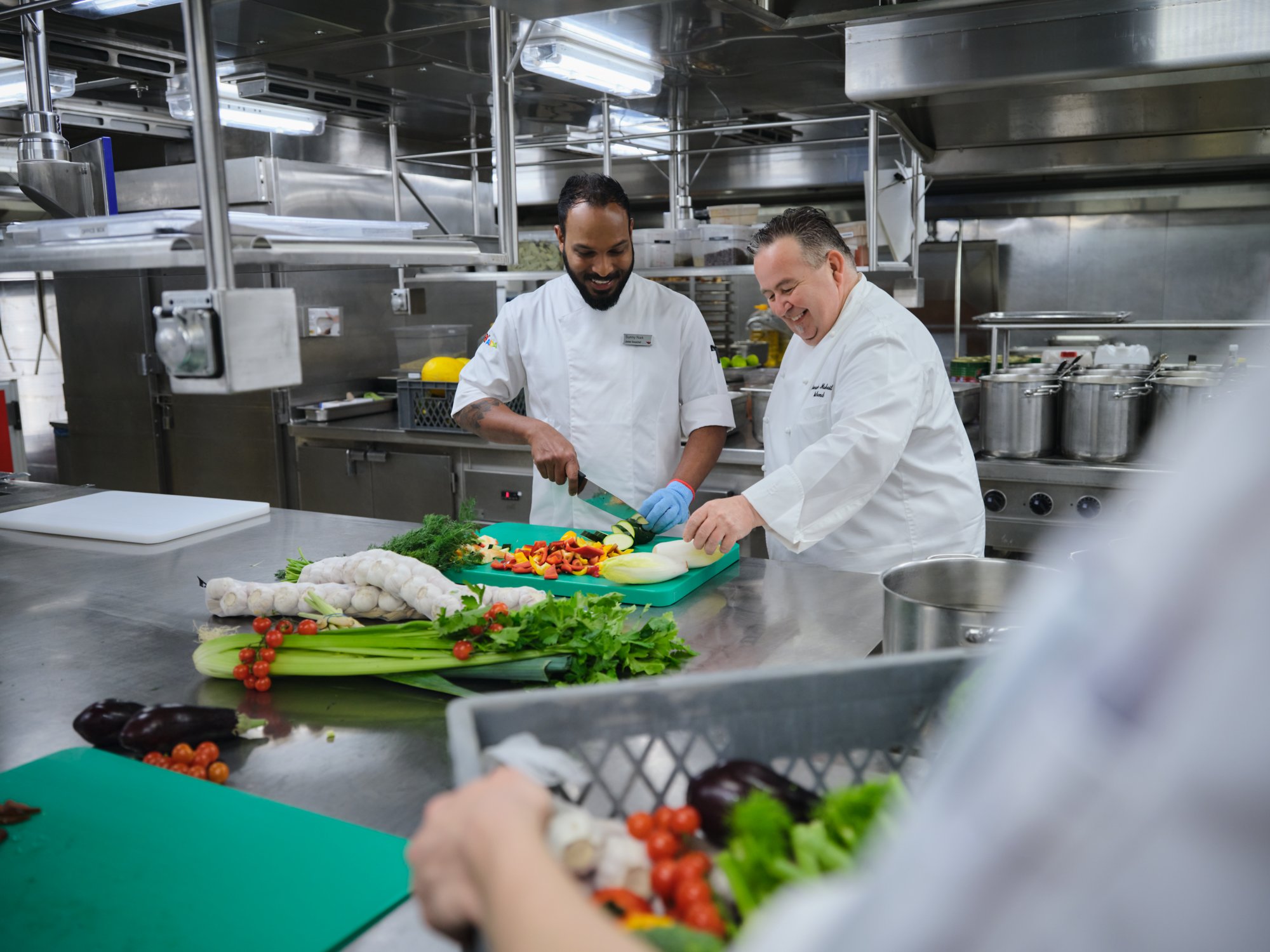 Chef in the AIDA Galley is cutting vegetables