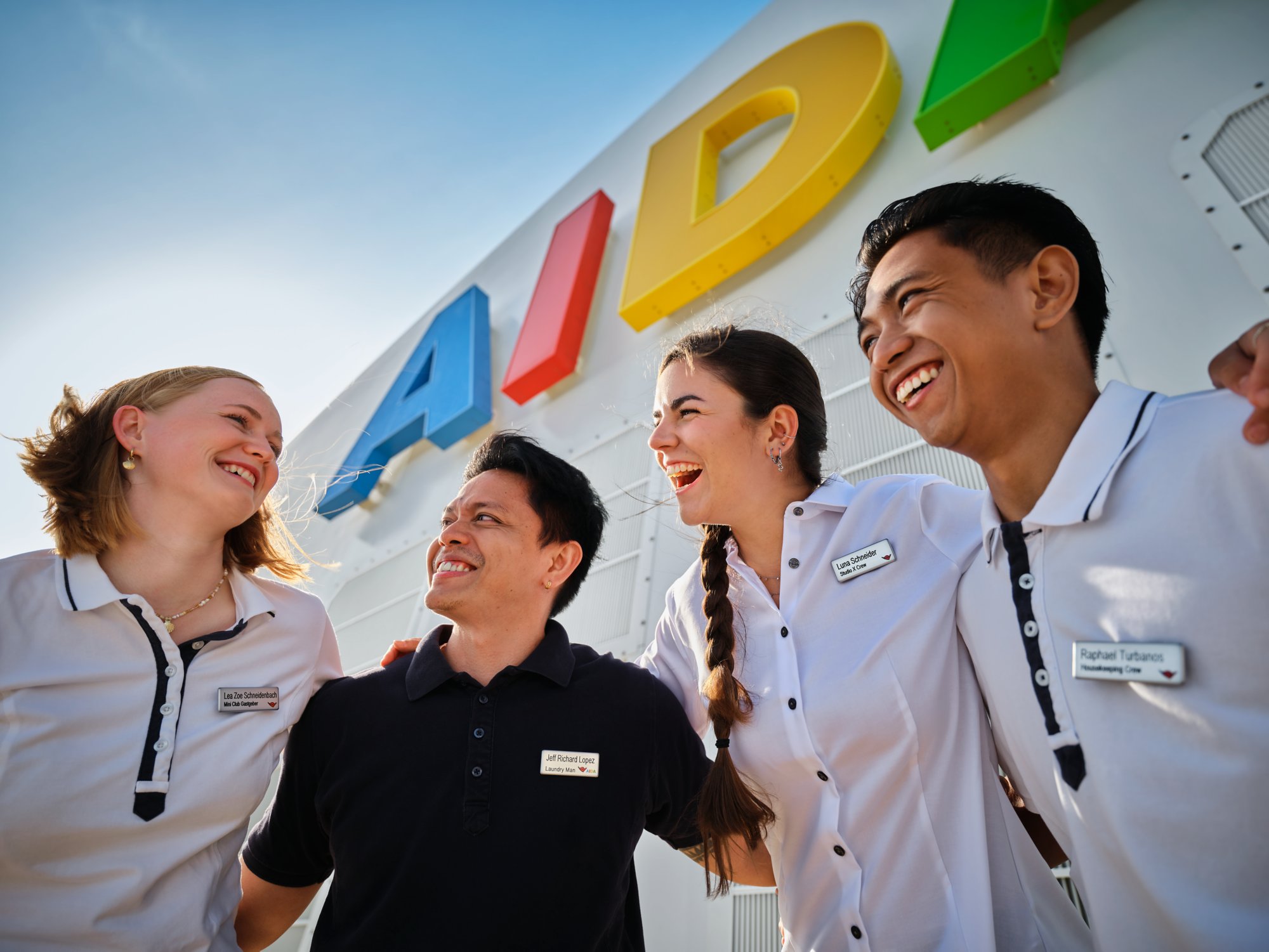 AIDA employees in front of AIDA letters 