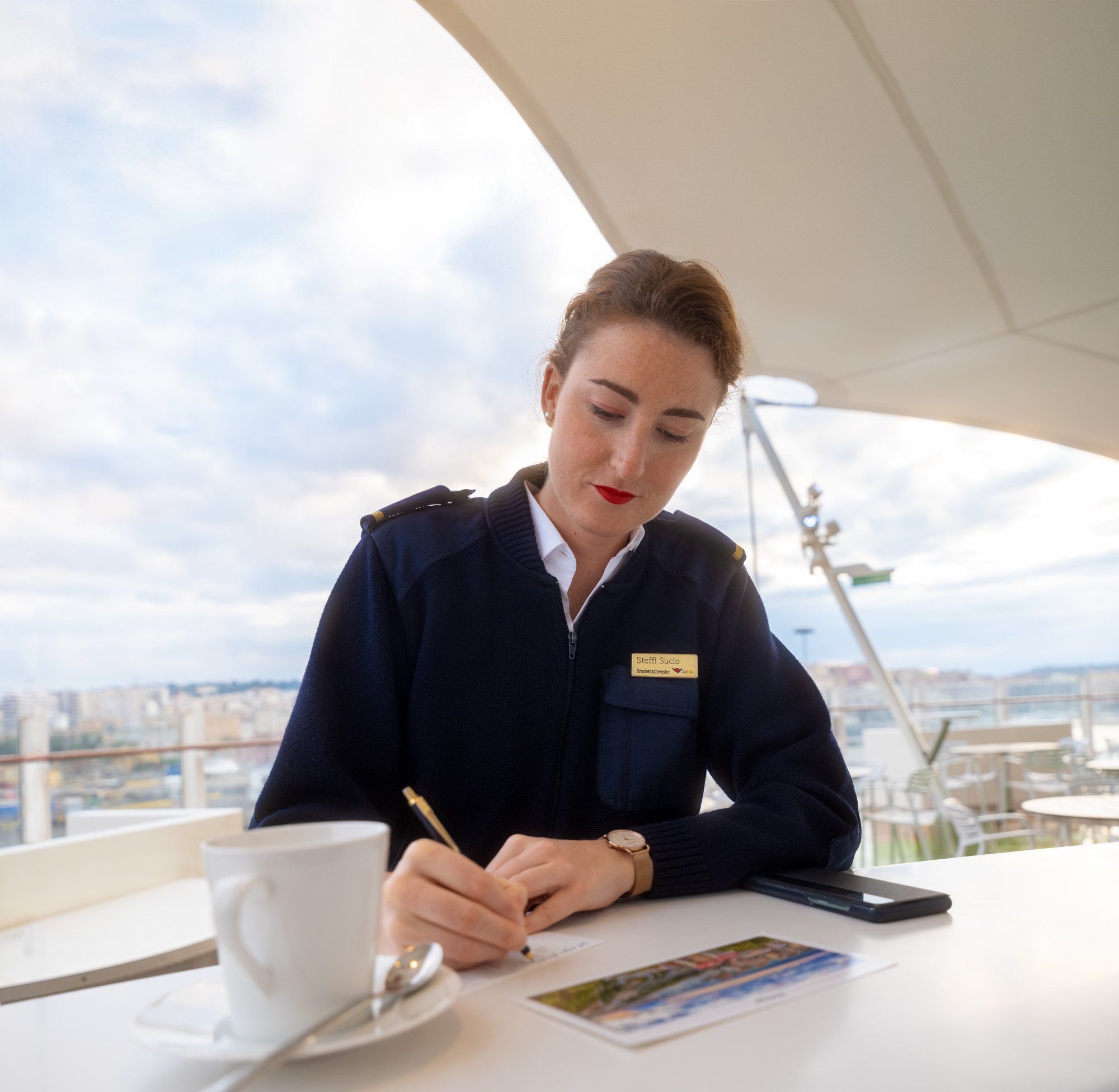 AIDA crew member writes a postcard