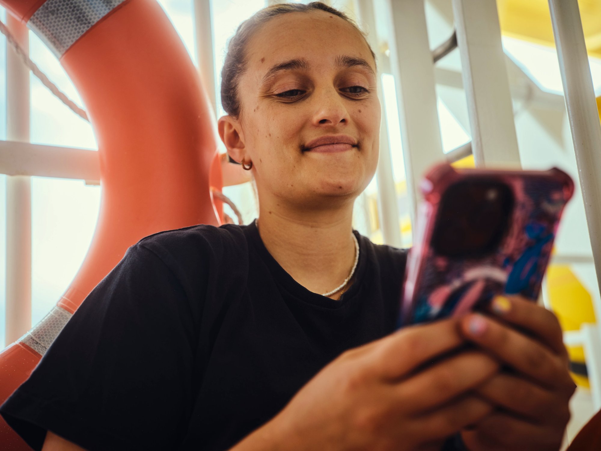 Crew member with mobile phone during break
