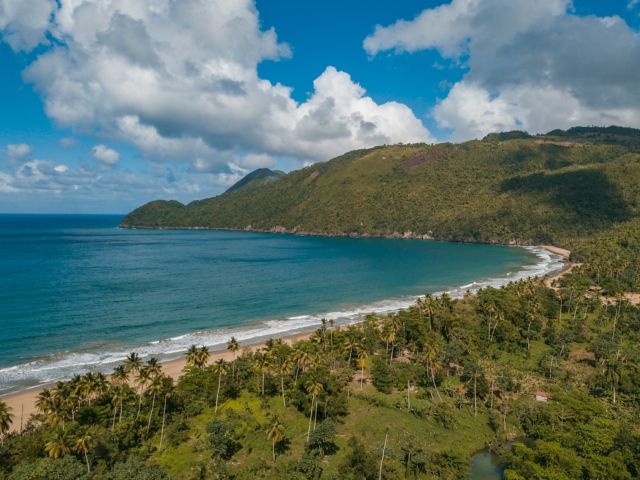 A landscape of El Valle Beach surrounded by greenery and sea in Samana, the Dominican Republic
