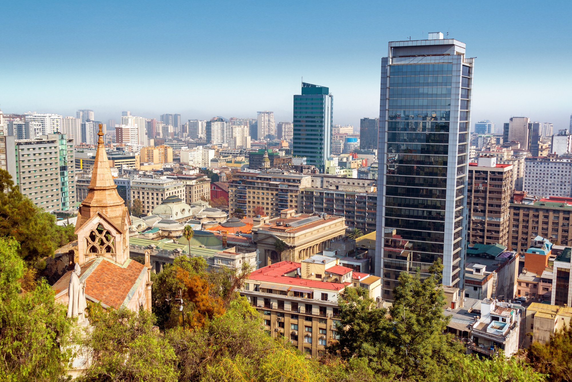 View of downtown Santiago, Chile with a church and statue in the foreground