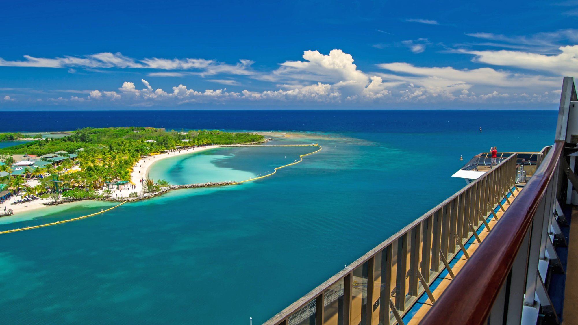 Beautiful beach resort on the tropical island viewed from the cruise ships open deck. Beach is located in Roatan Island, Honduras. Close to the beach is a natural coral reef. It is great for relaxation and diving and snorkeling. Fantastic destination.