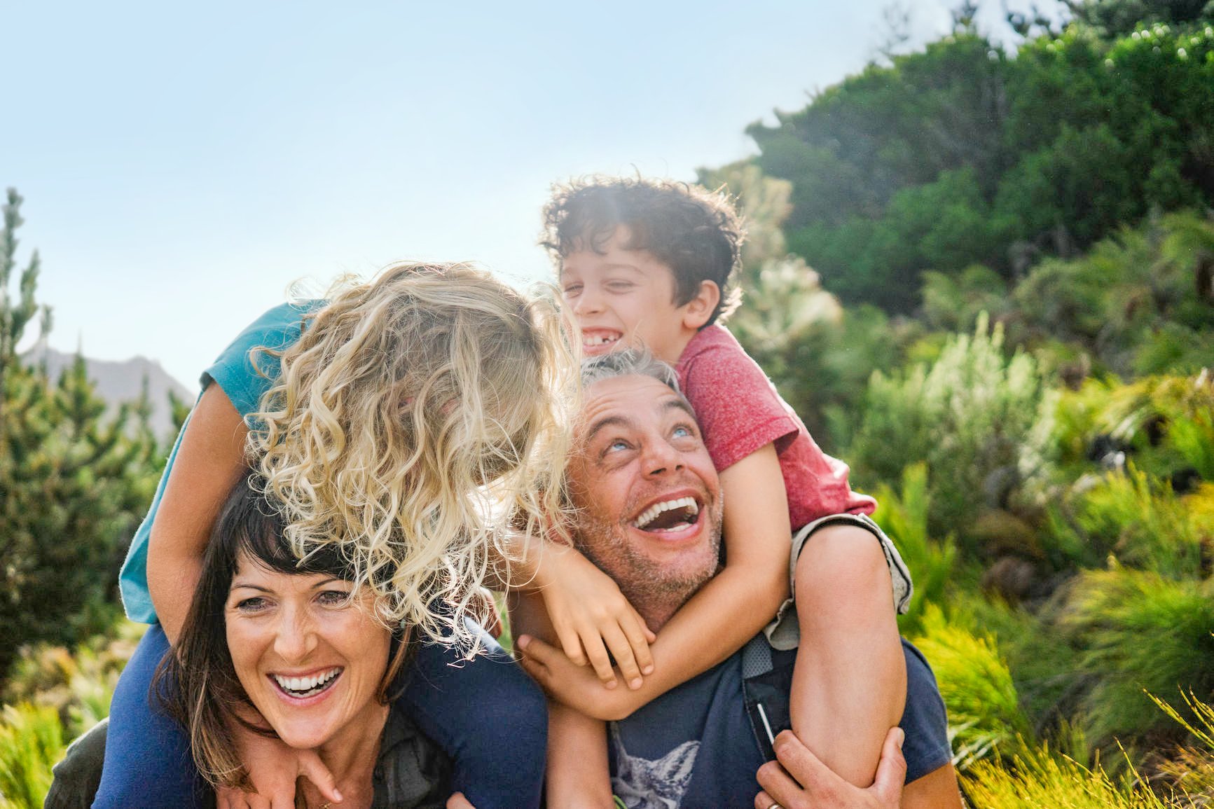 A family of four has fun in the mountains and play together