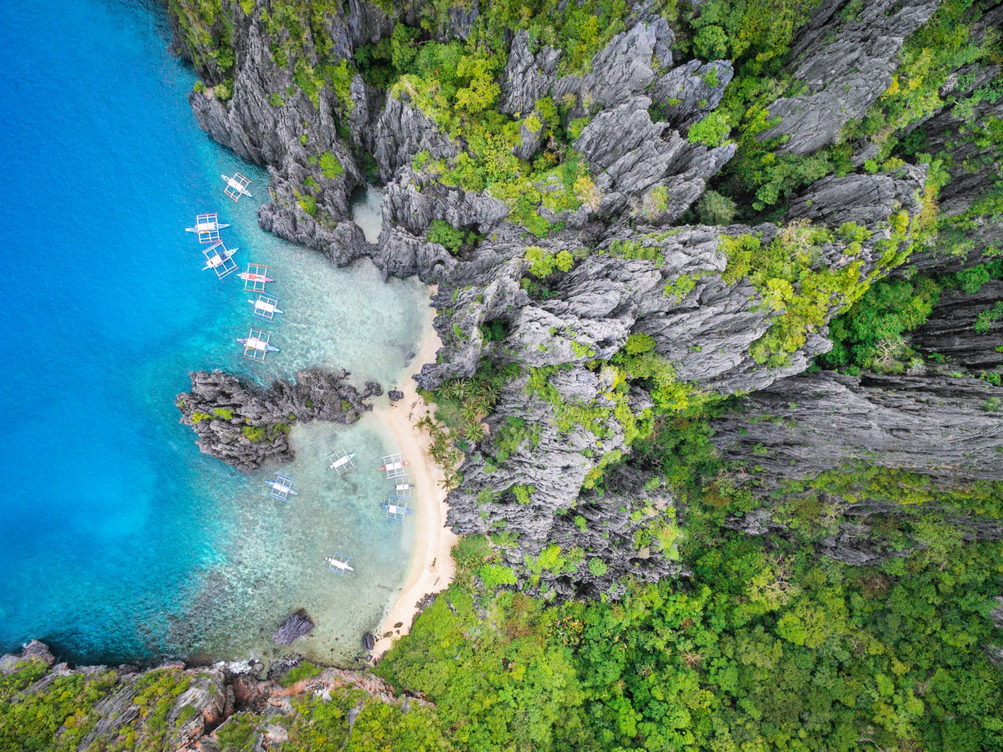 El Nido, Palawan, Philippines, aerial view of Secret Lagoon beach and dramatic karst scenery.