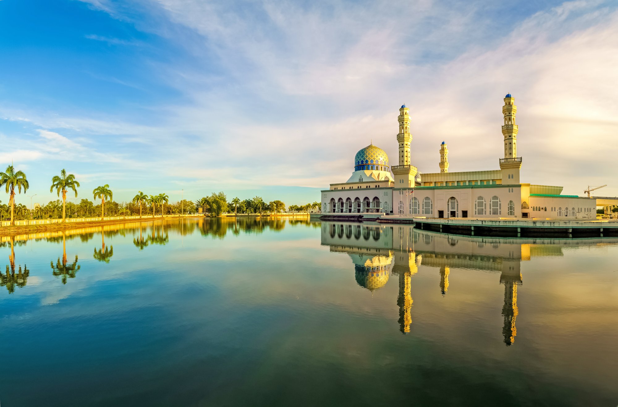 The Kota Kinabalu City Mosque locally known as Masjid Bandaraya with golden morning light and beautiful reflection.