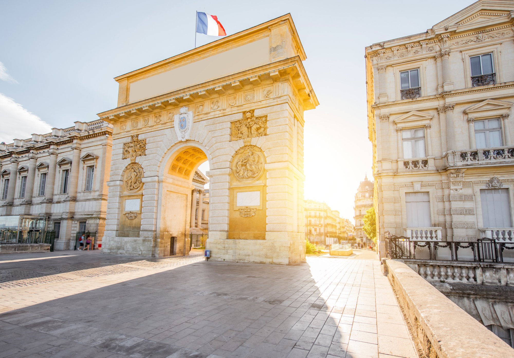 Street view with Triumphal Arch during the sunrise in Montpellier city in Occitanie region of France