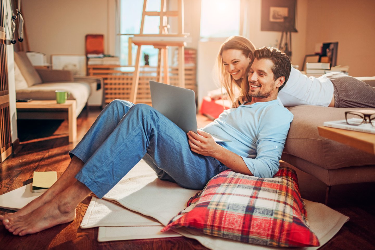 Close up of a happy young couple using laptop at home