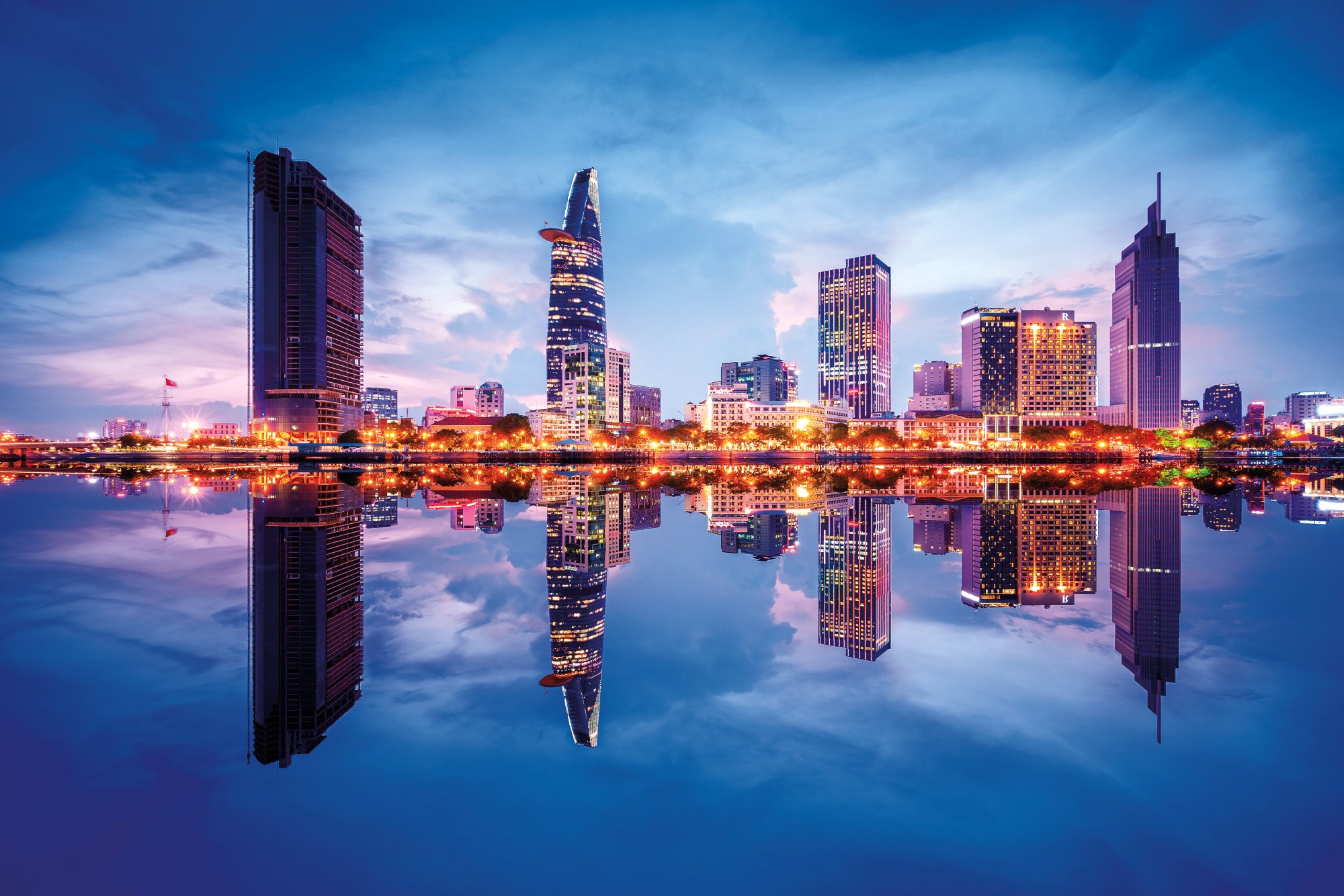 Cityscape in reflection of Ho Chi Minh city at beautiful twilight, viewed over Saigon river. Hochiminh city is the largest city in Vietnam with population around 10 million people