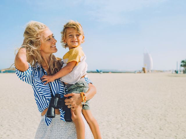 Young happy mother with little blonde son on the beach; Shutterstock ID 796966897; purchase_order: -; job: -; client: -; other: -