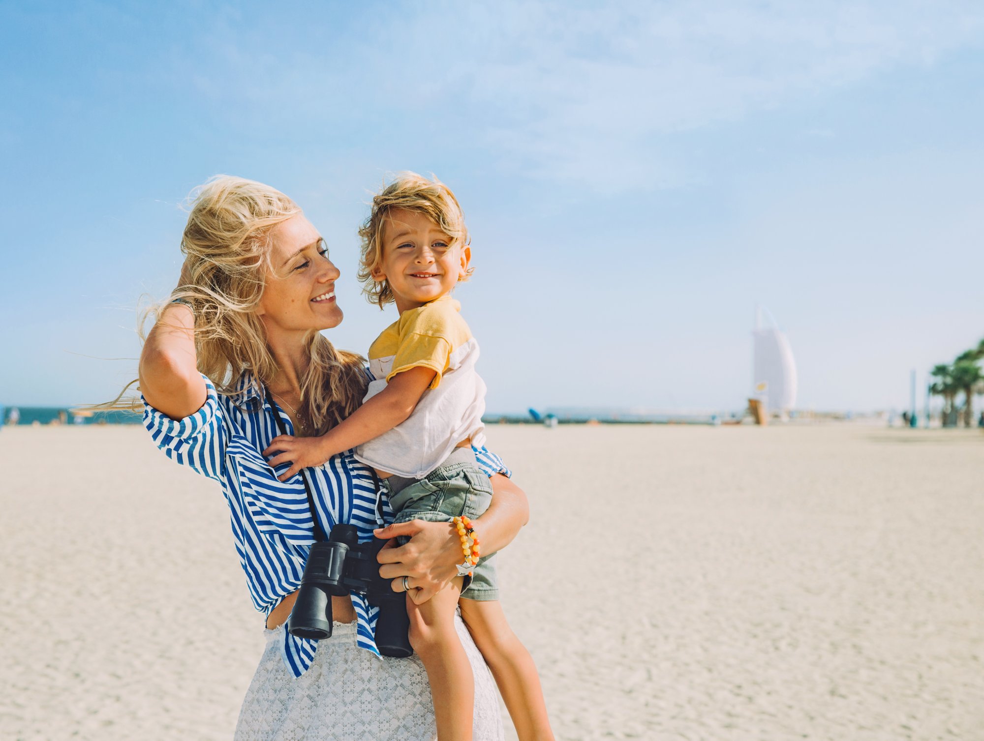 Young happy mother with little blonde son on the beach; Shutterstock ID 796966897; purchase_order: -; job: -; client: -; other: -