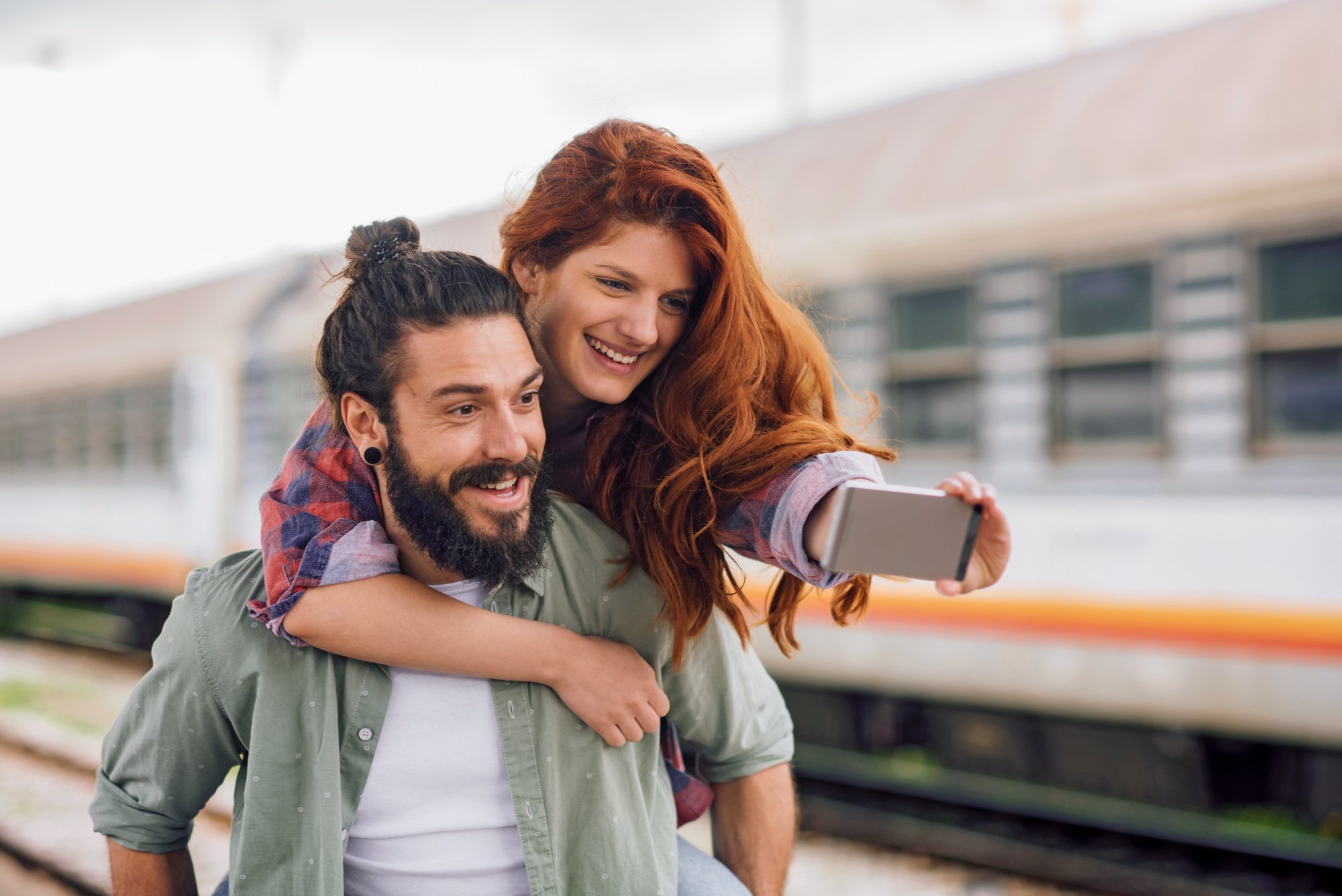 Couple having a selfie at the railroad station