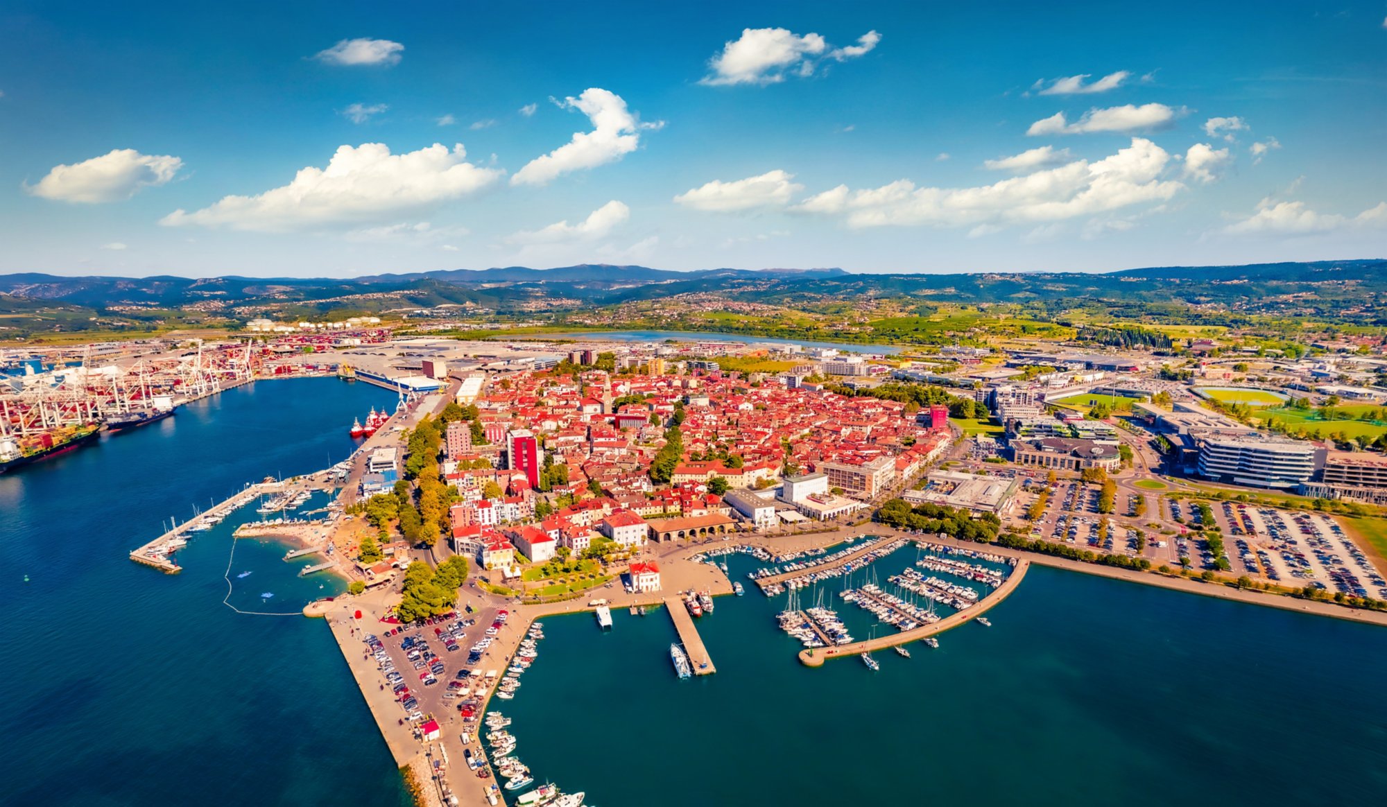 Incredible summer view from flying drone of Koper port. Aerial outdoor scene of Adriatic coastline, Slovenia, Europe. Stunning Mediterranean seascape. Traveling concept background.